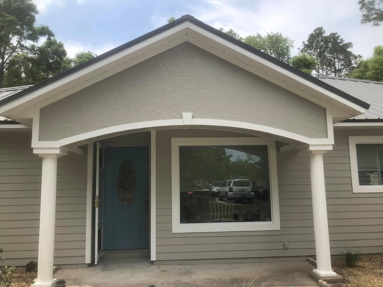 Same Gainesville home after fresh exterior paint and white trim by A+ Painting and Repair
