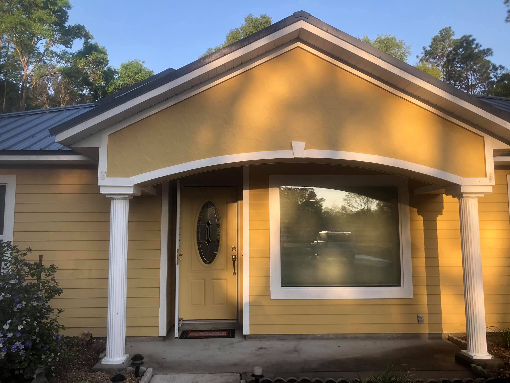 Front entry of a Gainesville home before exterior repaint and trim work