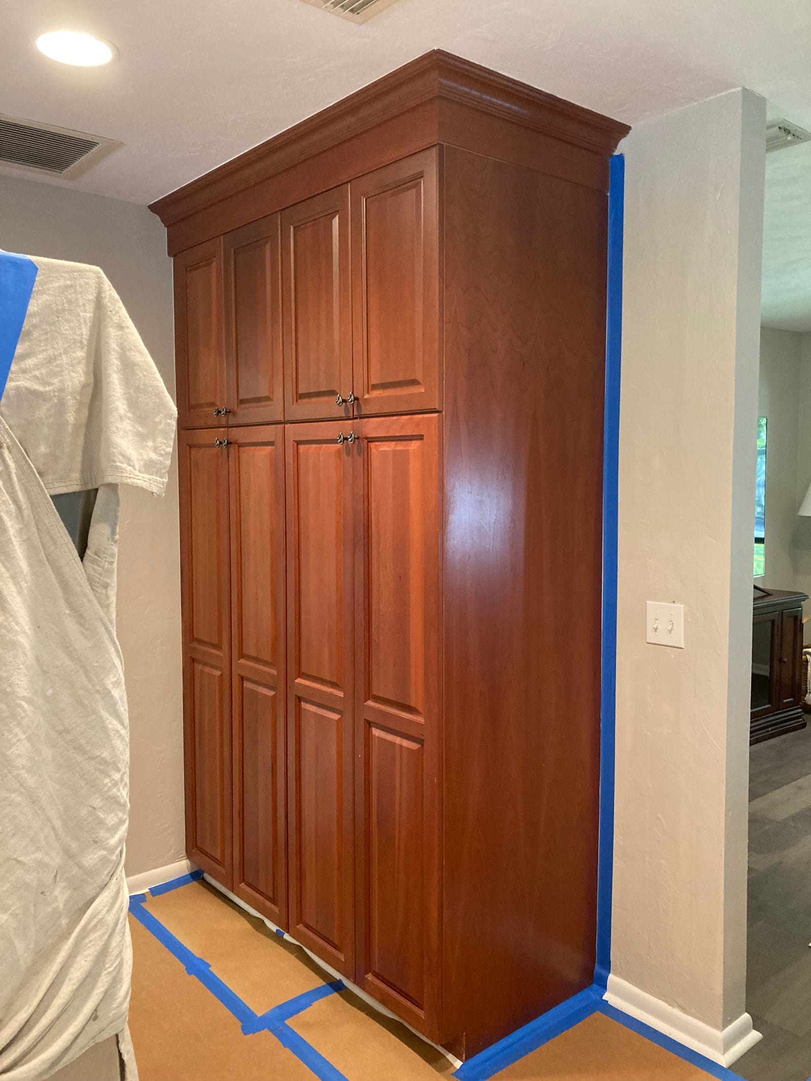 Dark wood built-in dresser before refinish