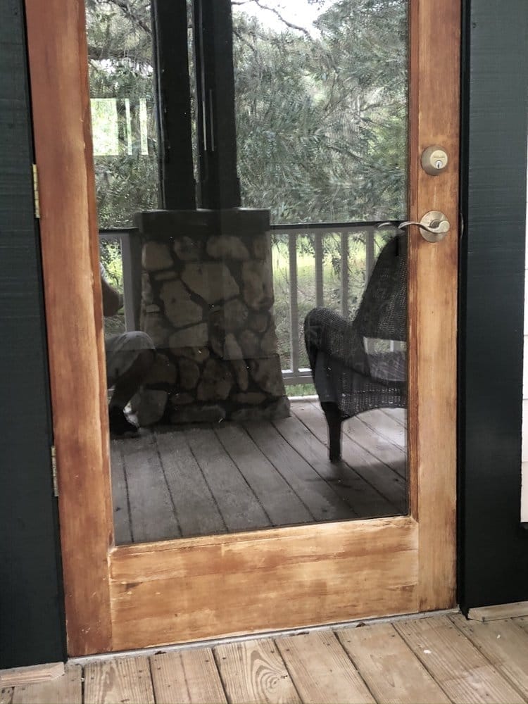 Screen door with weathered raw wood frame