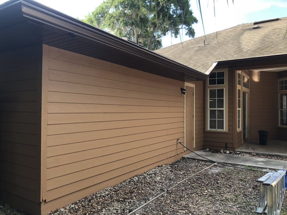 Patio side after, fresh tan paint and trim