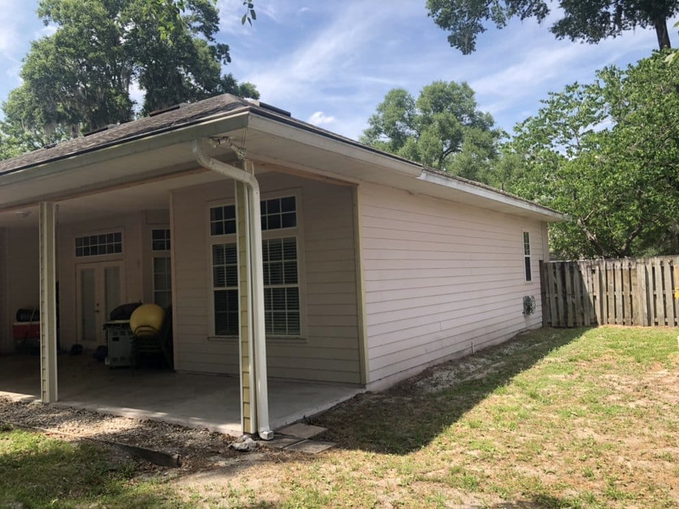 Siding home before repaint, weathered cream