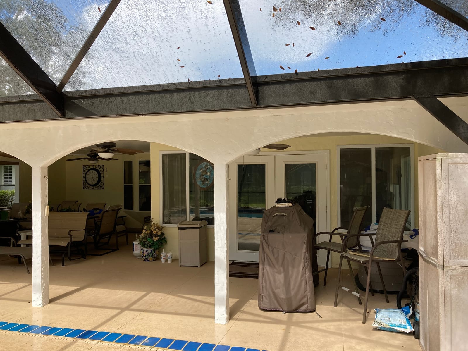 Lanai before repaint, beige stucco arches and walls
