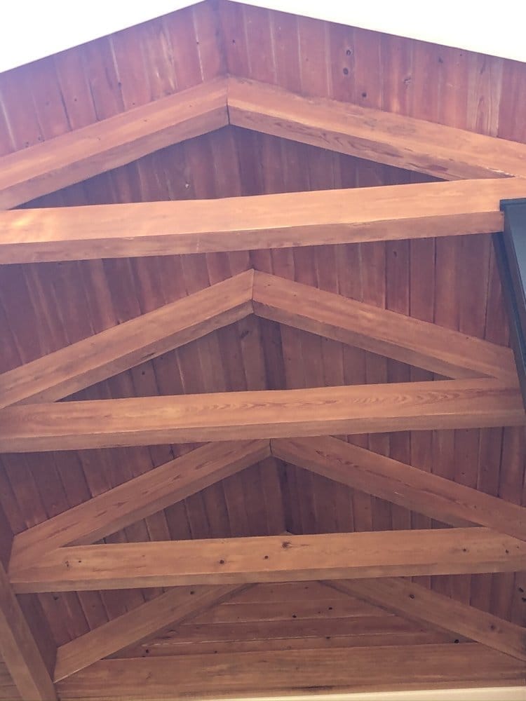 Gable vault wood beams looking up at the ridge, deep amber stain