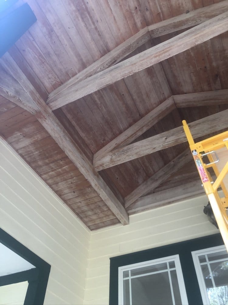 Porch ceiling wood beams before staining, weathered gray